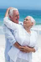 Senior couple embracing at the beach