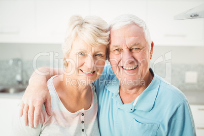 Portrait of cheerful senior couple in kitchen