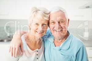 Portrait of cheerful senior couple in kitchen