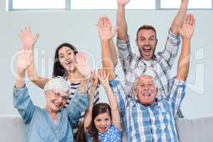 Happy family cheering in the living room