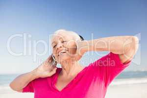 Senior woman listening music with headphone