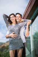 Romantic young couple embracing in balcony