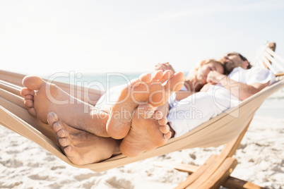 Couple sleeping in hammock