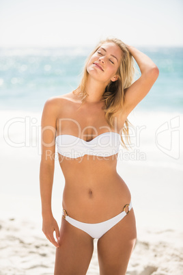 Woman with eyes closed standing at the beach