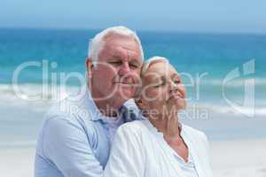 Senior couple embracing at the beach