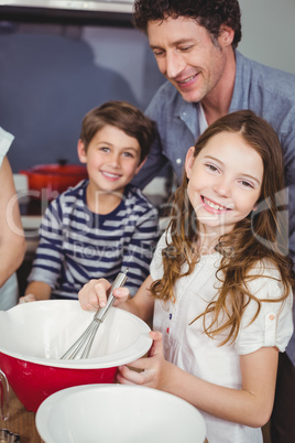 Portrait of children with father in kitchen