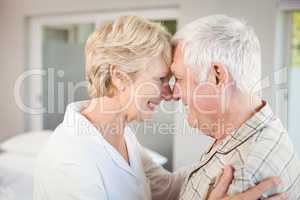 Side view of happy couple touching nose