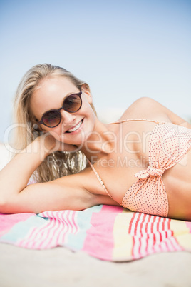 Pretty woman in bikini lying on the beach