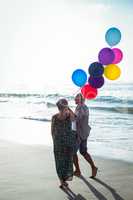 Senior couple holding balloons