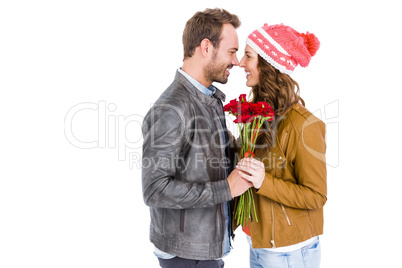 Happy young couple holding a flower bouquet