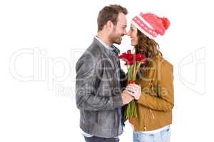 Happy young couple holding a flower bouquet