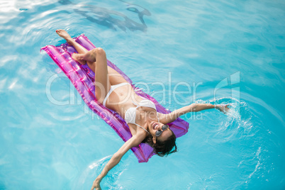 Young woman swimming with inflatable raft