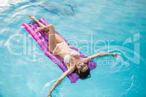 Young woman swimming with inflatable raft