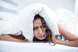 Portrait of irritated woman lying on bed
