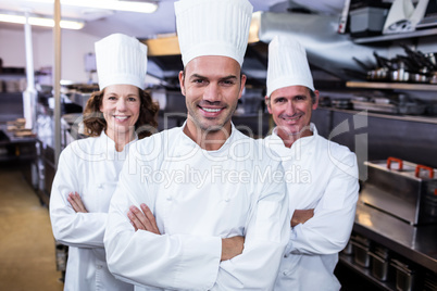 Team of chefs standing with arms crossed