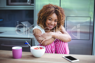Happy woman sitting by table during breakfast