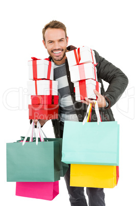 Young man holding gifts and shopping bags