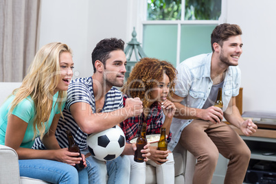 Multi-ethnic friends watching soccer match