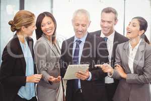 Businesspeople interacting and using digital tablet