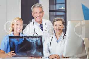 Portrait of smiling doctor team with X-ray