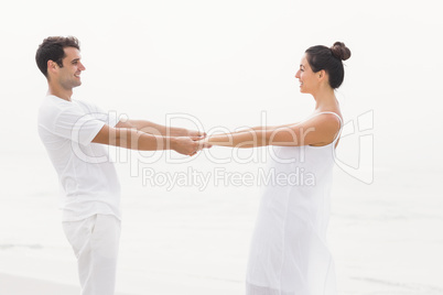 Romantic couple holding hands on the beach