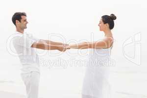 Romantic couple holding hands on the beach