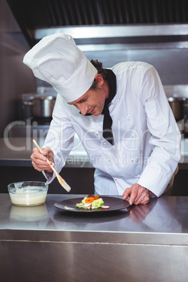 Chef putting sauce on a dish