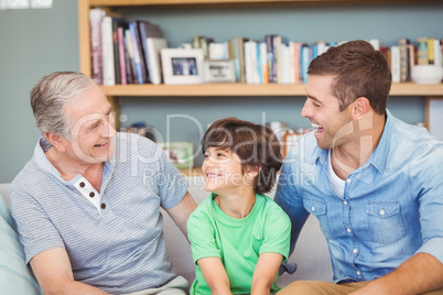 Happy multi genration family sitting on sofa