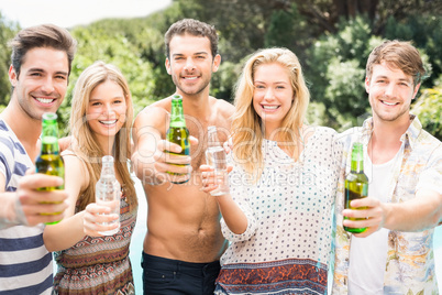 Group of friends showing their beer bottles