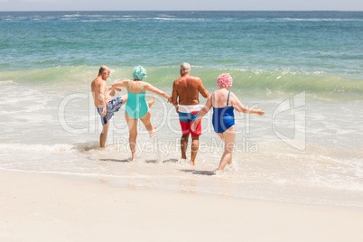 Senior friends playing in water