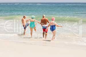 Senior friends playing in water