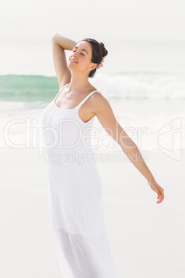 Beautiful woman stretching on the beach