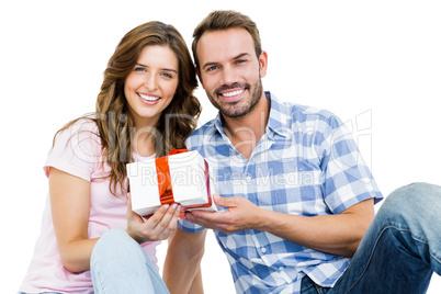 Happy young couple holding gift