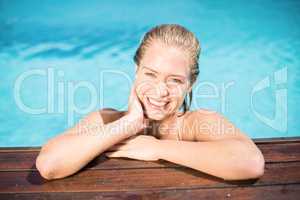 Portrait of beautiful woman leaning on poolside