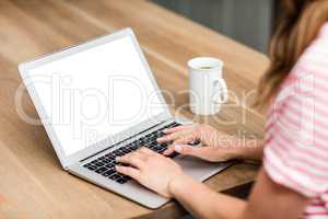 Cropped image of woman typing in laptop