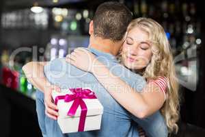 Cute couple hugging having a gift