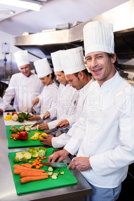 Team of chefs chopping vegetables