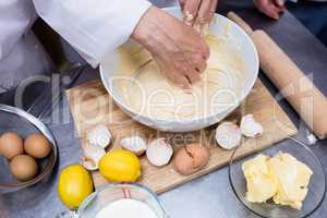Chef preparing dough at counter