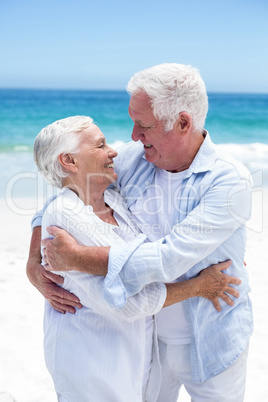 Senior couple embracing and looking to each other