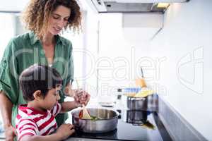 Mother and son cooking in kitchen