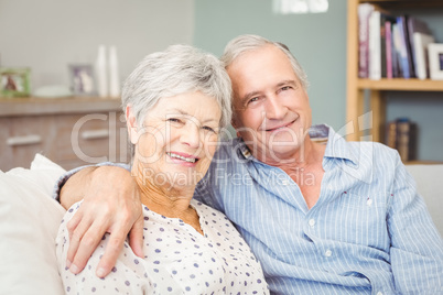 Portrait of senior couple sitting on sofa