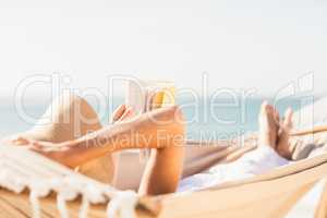 Woman reading book in hammock