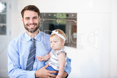 Happy businessman carrying daughter