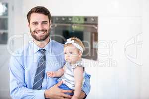 Happy businessman carrying daughter