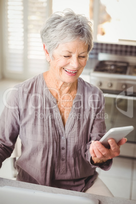 Happy senior woman using mobile phone