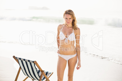 Portrait of pretty woman in bikini standing on the beach