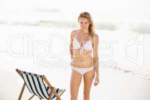 Portrait of pretty woman in bikini standing on the beach