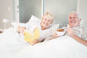Couple reading book in bed at home
