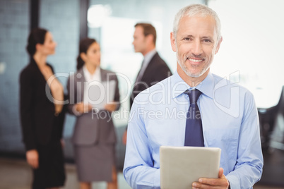 Portrait of businessman with digital tablet