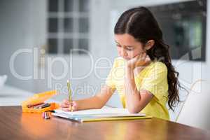 Girl studying while sitting at desk
